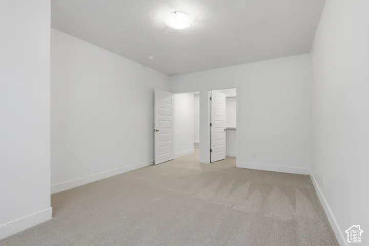 Neutral-toned carpeting with white walls and trim