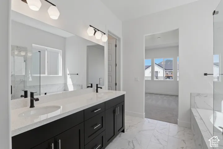 Dual vanity with quartz countertop, black cabinetry, and matte black fixtures