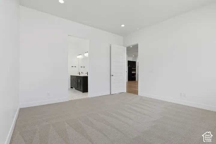 Neutral-toned carpeting with recessed lighting