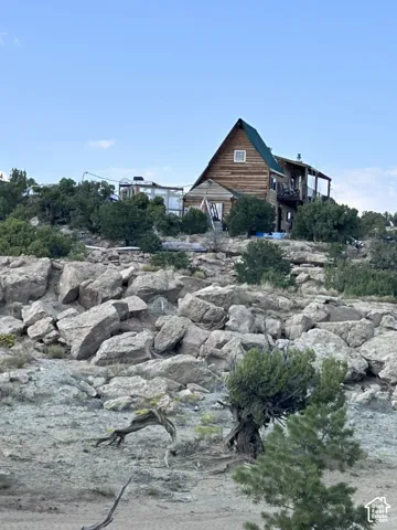 Log cabin style exterior with a green gabled roof