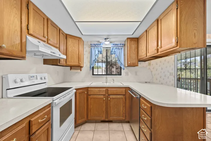 Wood-finish cabinetry paired with white countertops and a tile backsplash