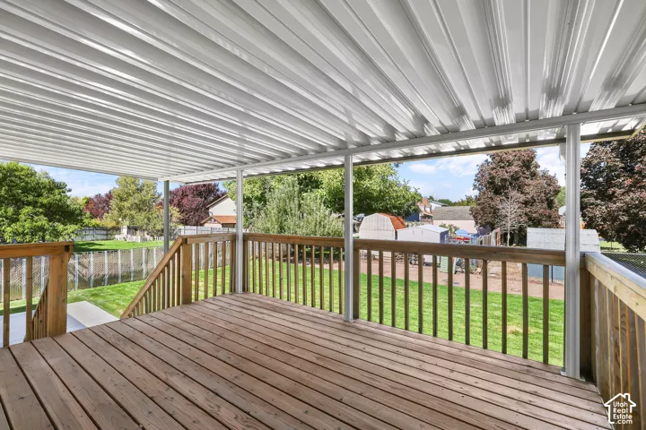 Covered wood deck with metal roofing and wood railing