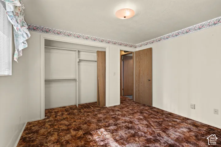 Wall-to-wall carpeting in a rich brown tone, paired with neutral painted walls