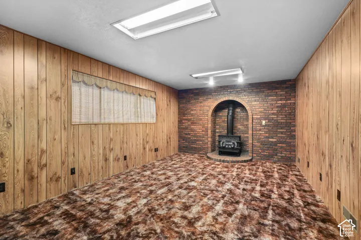 Brick accent wall with an arched alcove and a built-in wood-burning stove