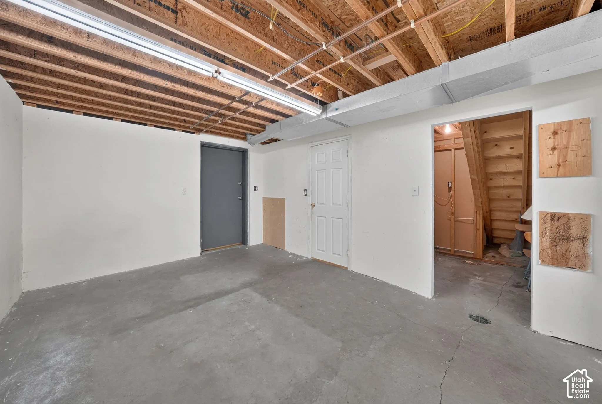 Lower level room with attached bathroom. Possible laundry/closet under the stairs.