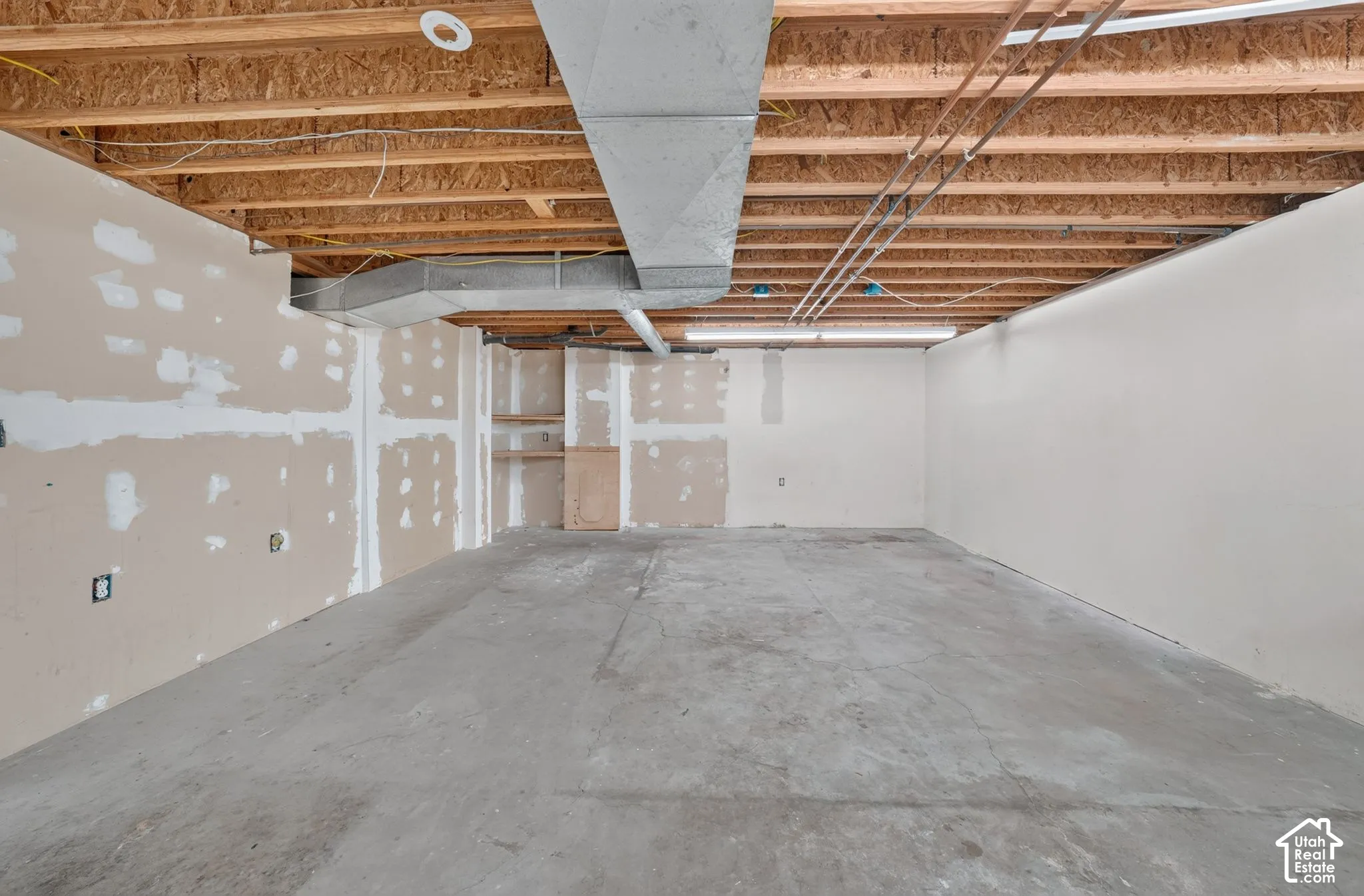 Basement space. Could be a kitchenette and living room area.