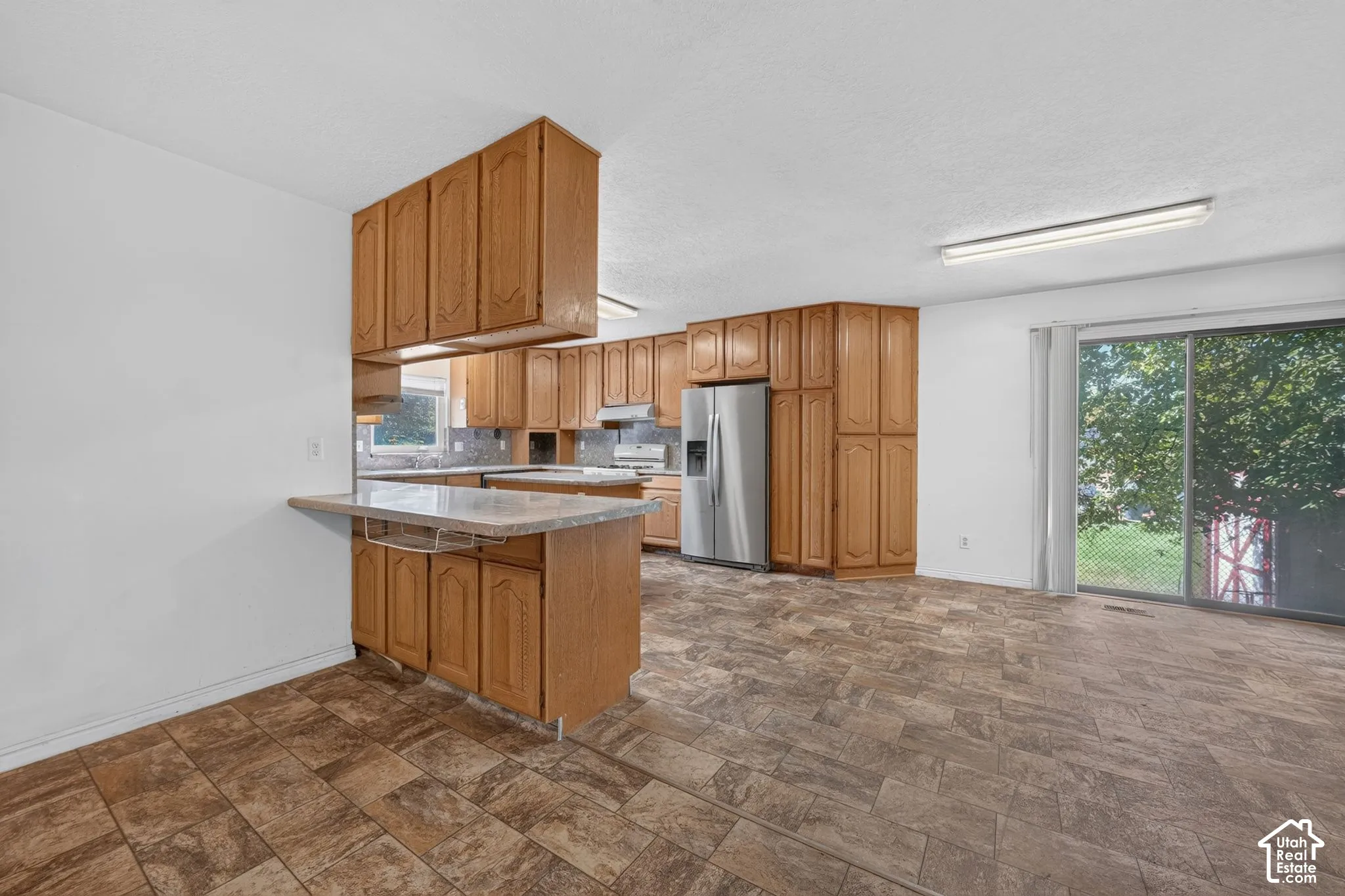 Kitchen featuring wood cabinetry and breakfast bar.