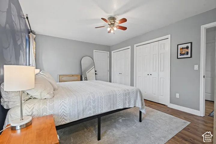 Wood-finish flooring, ceiling fan, and two bi-fold door closets