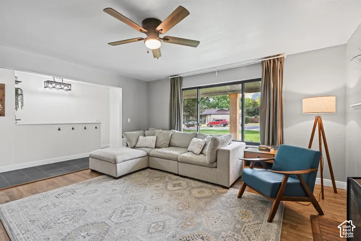 Recessed lighting, wood-finish flooring, ceiling fan, large window, and wall-mounted coat hooks