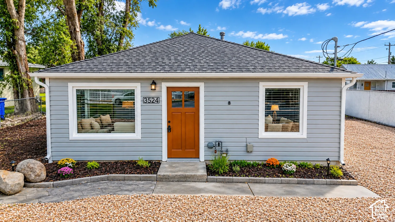 Light gray siding exterior with a dark shingle roof