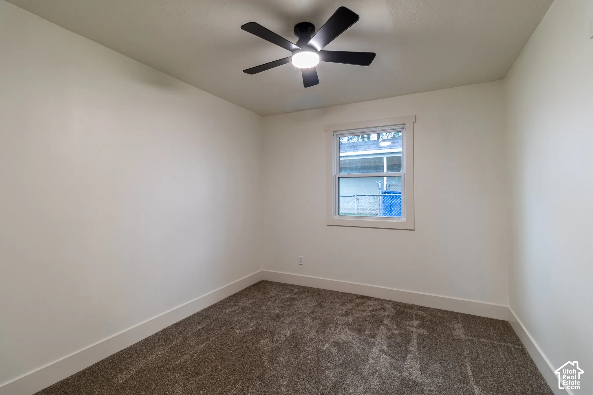 Neutral-toned walls complement the textured carpet flooring