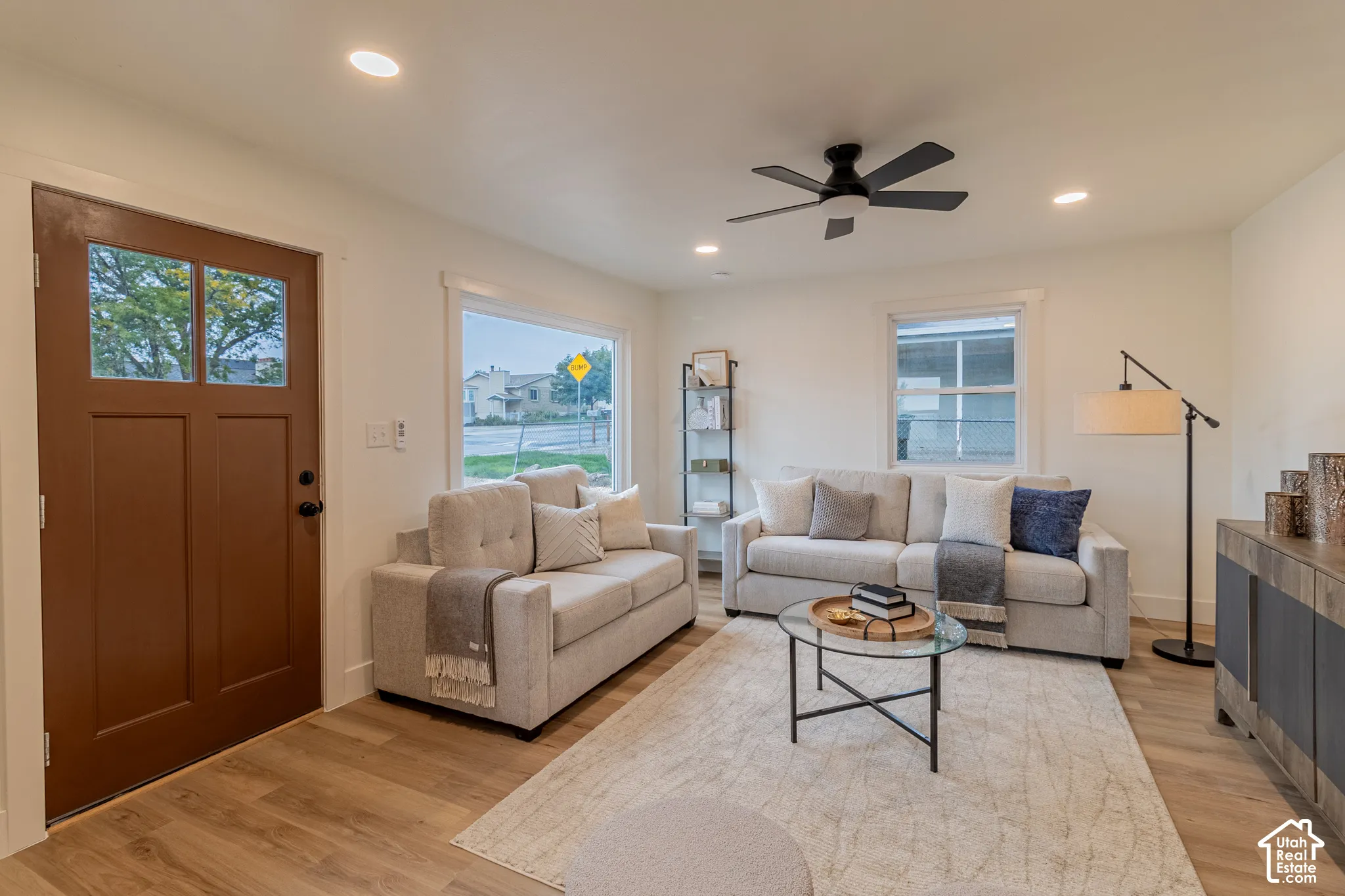 Recessed lighting, wood-finish flooring, and a ceiling fan