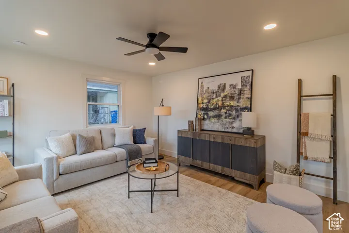 Recessed lighting, ceiling fan, wood-finish flooring, white walls, and a window with white trim