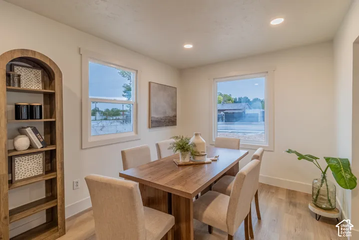 Recessed lighting, wood-finish flooring, white trim, and multiple windows