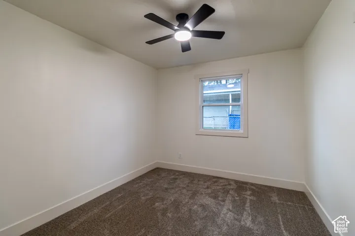 Neutral-toned walls complement the textured carpet flooring
