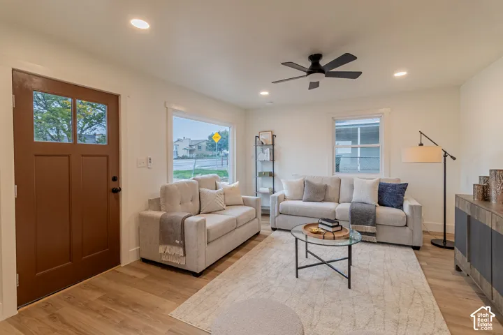 Recessed lighting, wood-finish flooring, and a ceiling fan
