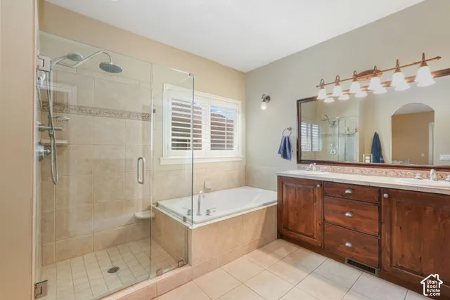 Walk-in shower with clear glass enclosure and tile surround