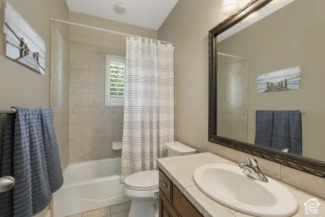 Bathroom featuring a tiled shower/tub combination, single vanity with a white basin, and a framed mirror