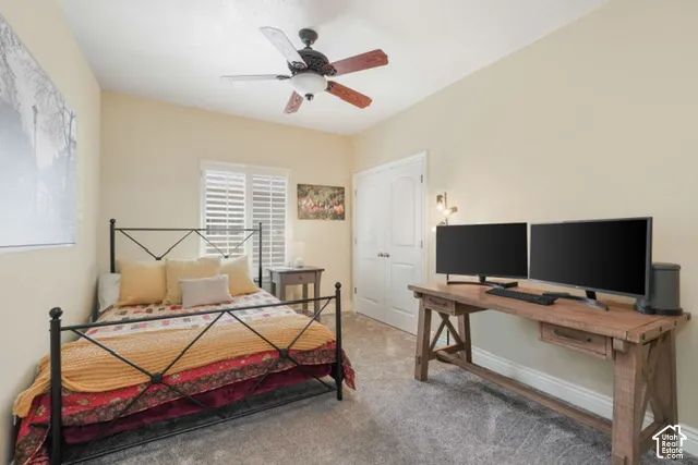 Recessed lighting, ceiling fan, bi-fold doors, window with plantation shutters, and wood-finish desk