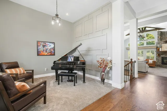 Two-story entryway with wood-finish flooring, accent wall paneling, and a contemporary chandelier