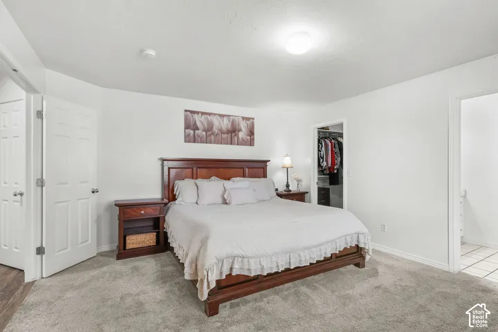 Recessed lighting, light-toned carpeting, white interior doors, and a built-in closet with shelving