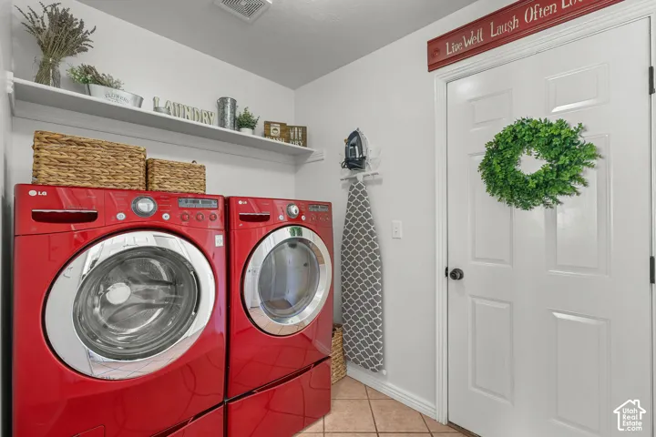Built-in shelving, white paneled door, and tile flooring