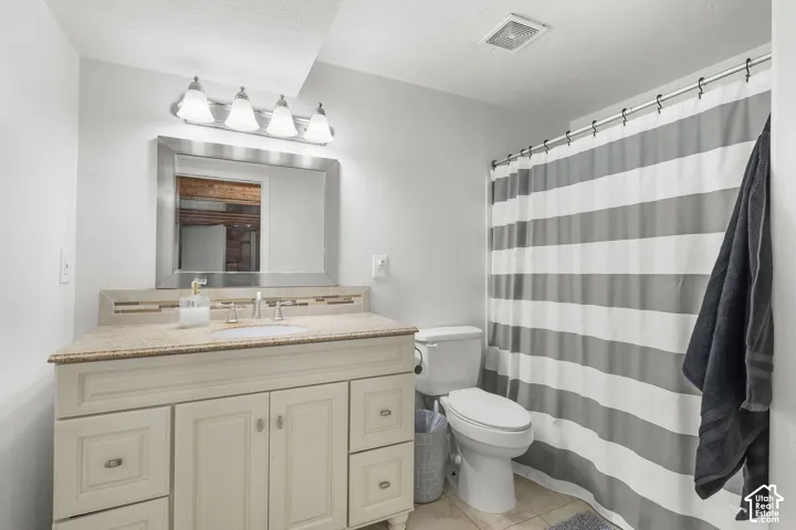 Vanity with a light-colored countertop, undermount sink, and brushed nickel faucet