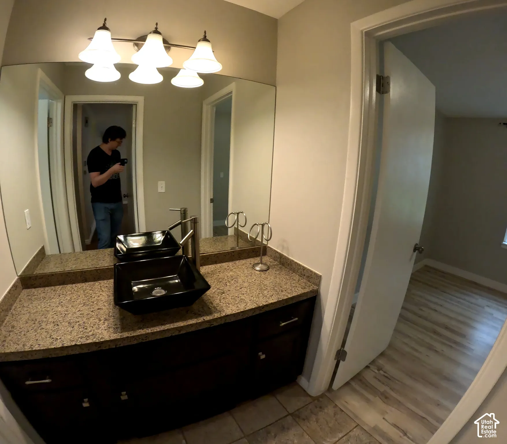 Bathroom vanity with dark cabinetry