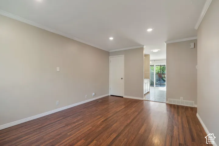 Recessed dimmable lighting, light neutral wall paint, white crown molding and  trim