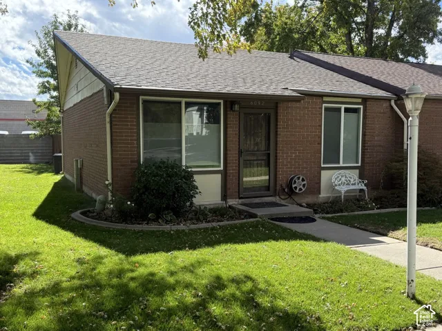 Brick exterior with a gabled roof and white gutters