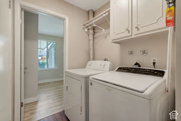 Laundry area featuring built-in white cabinetry with open shelving