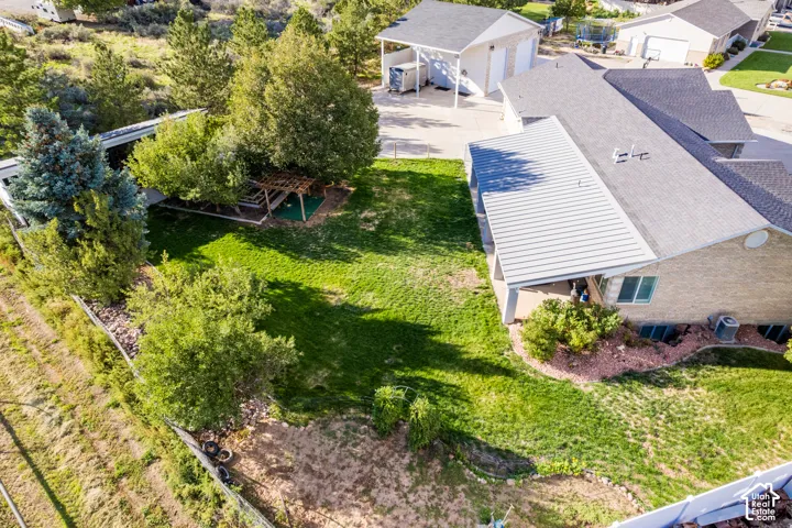Expansive green lawn with mature trees and a dedicated pergola area