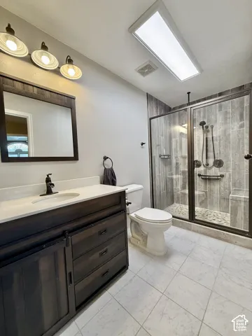 Vanity with a light-toned countertop and dark wood-finish cabinetry
