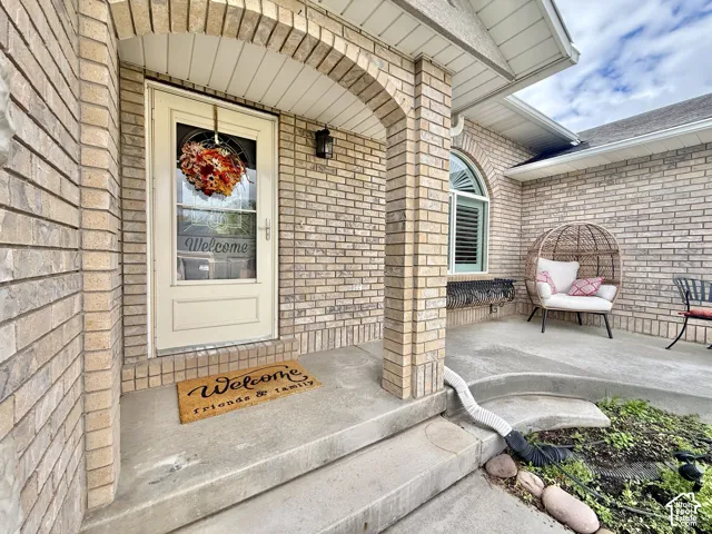 Brick exterior with an arched entryway and covered porch