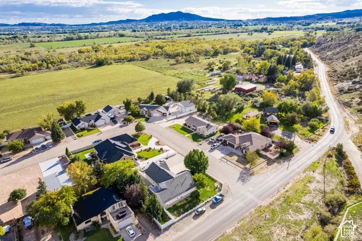 Residential neighborhood featuring paved roads, established homes, and surrounding green spaces