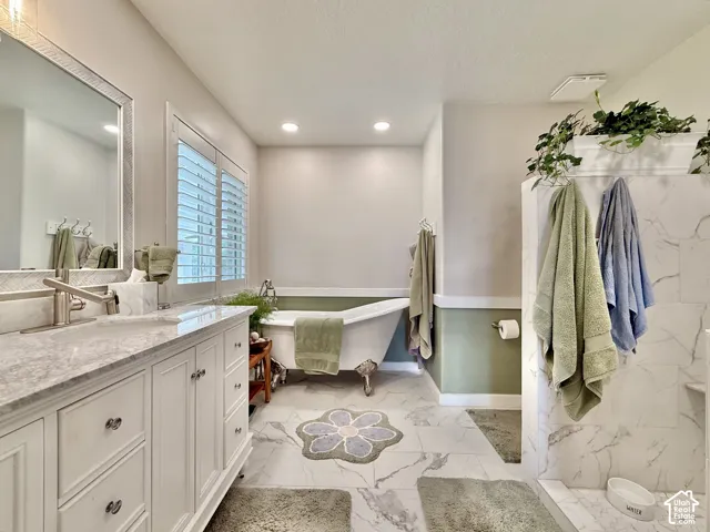 White shaker-style vanity with a light-colored countertop and undermount sink
