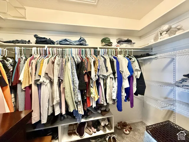 Built-in closet system featuring multiple hanging rods, white wire shelving, and integrated shoe cubbies