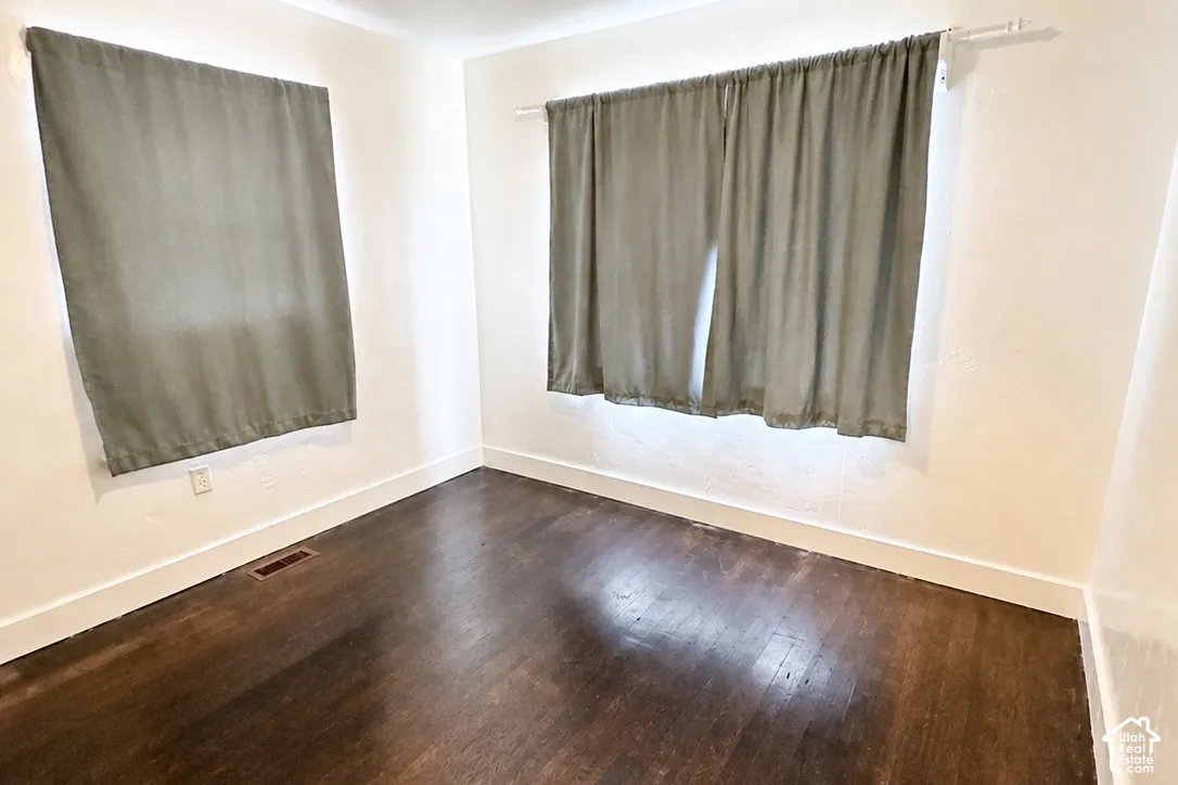 White walls with dark wood-finish flooring