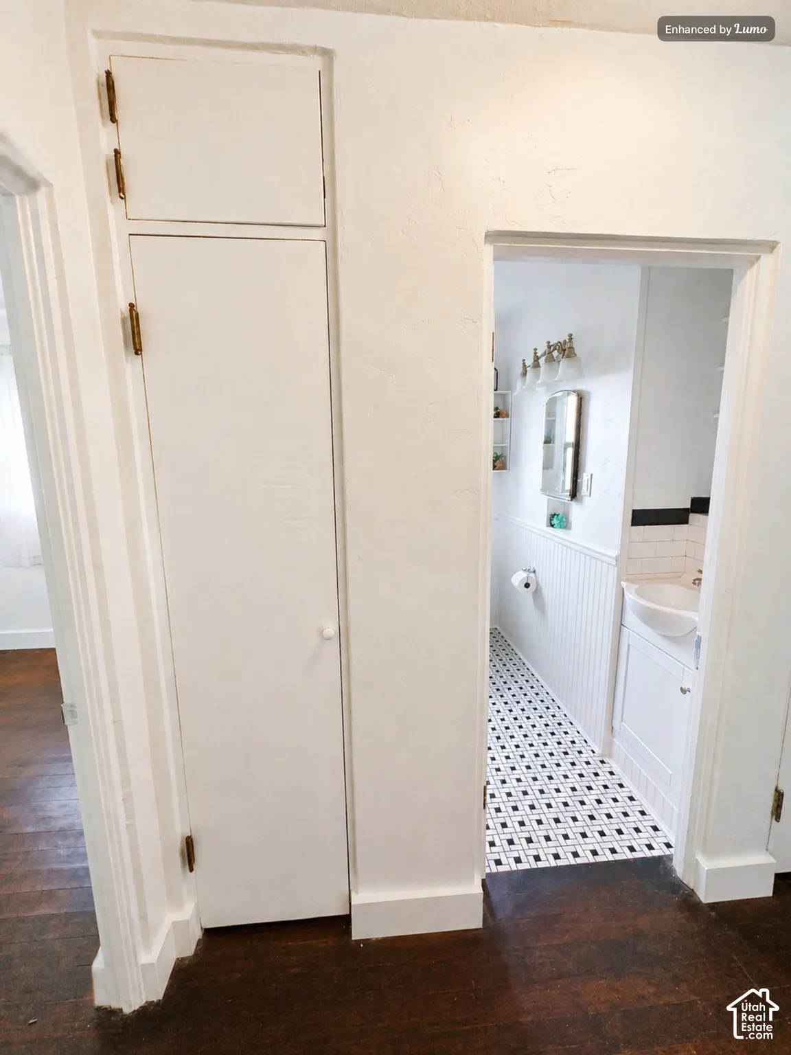 Rich wood-finish flooring extending into the hallway