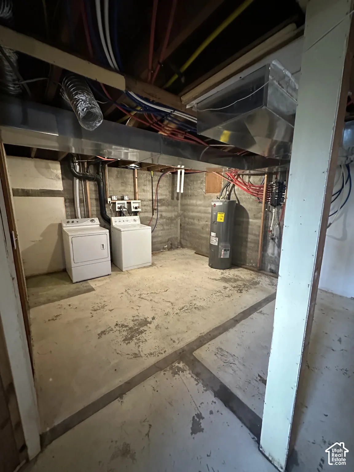 Concrete flooring with exposed ceiling joists and utility lines