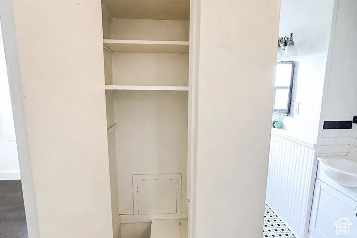 Built-in shelving with multiple storage compartments, laundry shute
