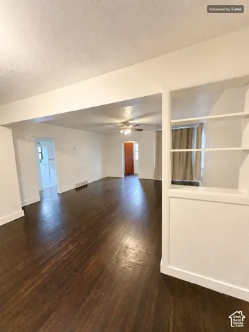 Hardwood flooring extends throughout the space, complemented by crisp white walls