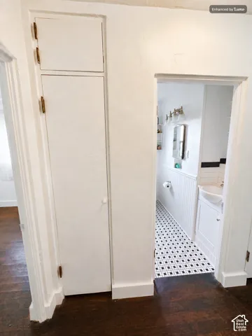 Rich wood-finish flooring extending into the hallway