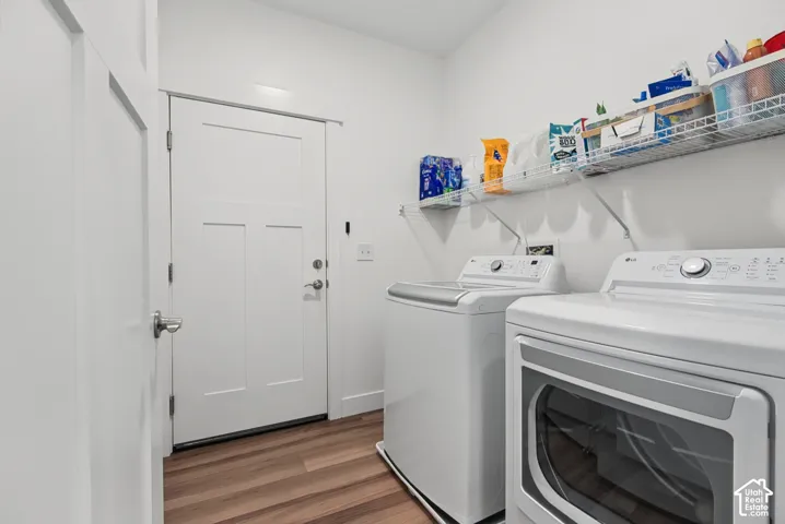 White walls with wood-finish flooring, featuring a built-in wire shelving system