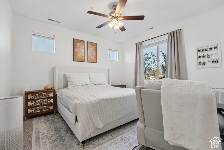 Recessed lighting, ceiling fan with light fixture, large window with curtain rods, and a window with blinds