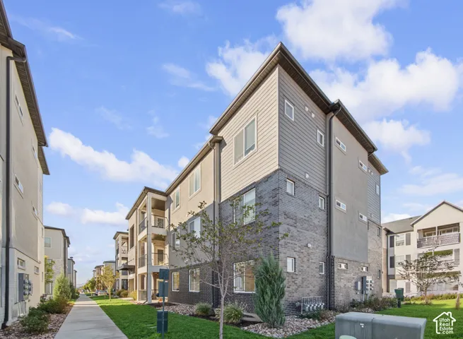 Modern multi-story building featuring stucco and horizontal siding