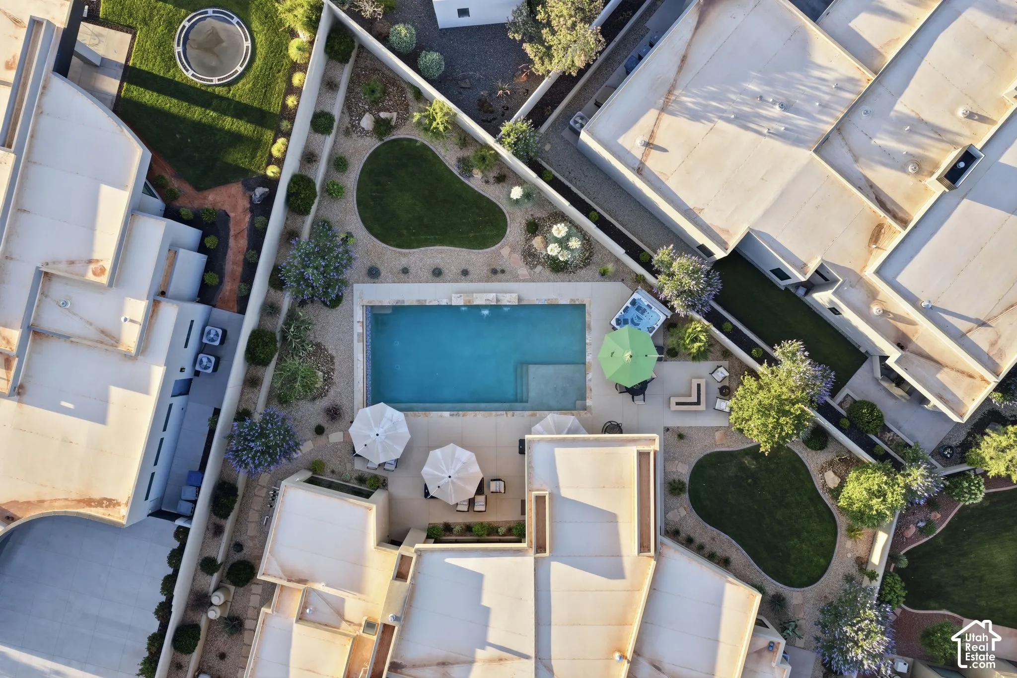 Private courtyard featuring a rectangular swimming pool, multiple grass lawns, and established landscaping