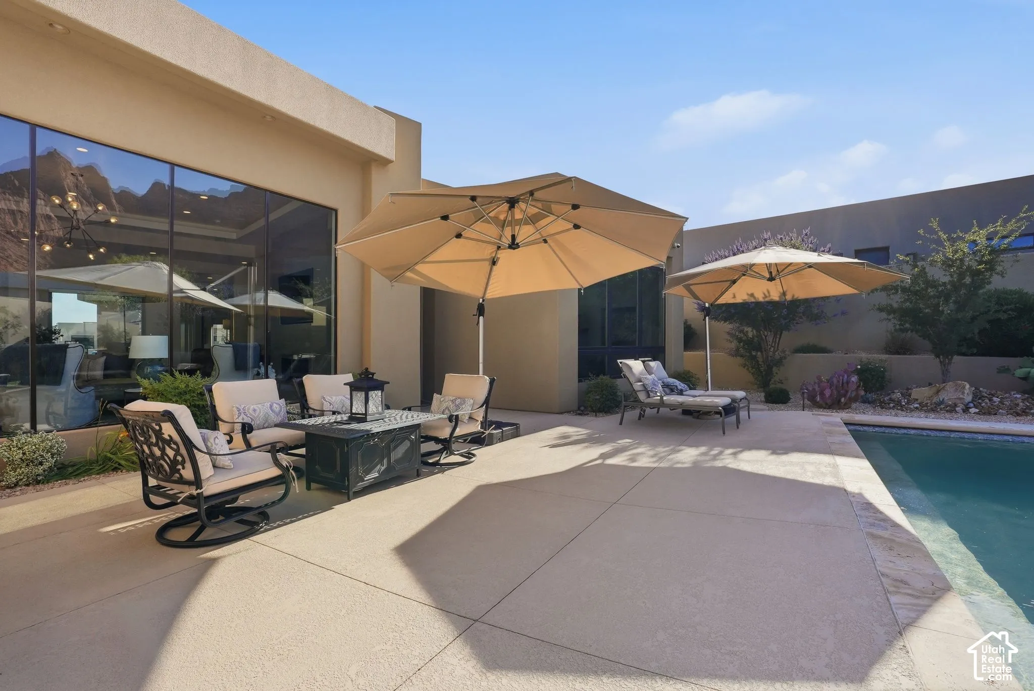 Expansive outdoor patio with concrete surfacing and an integrated swimming pool