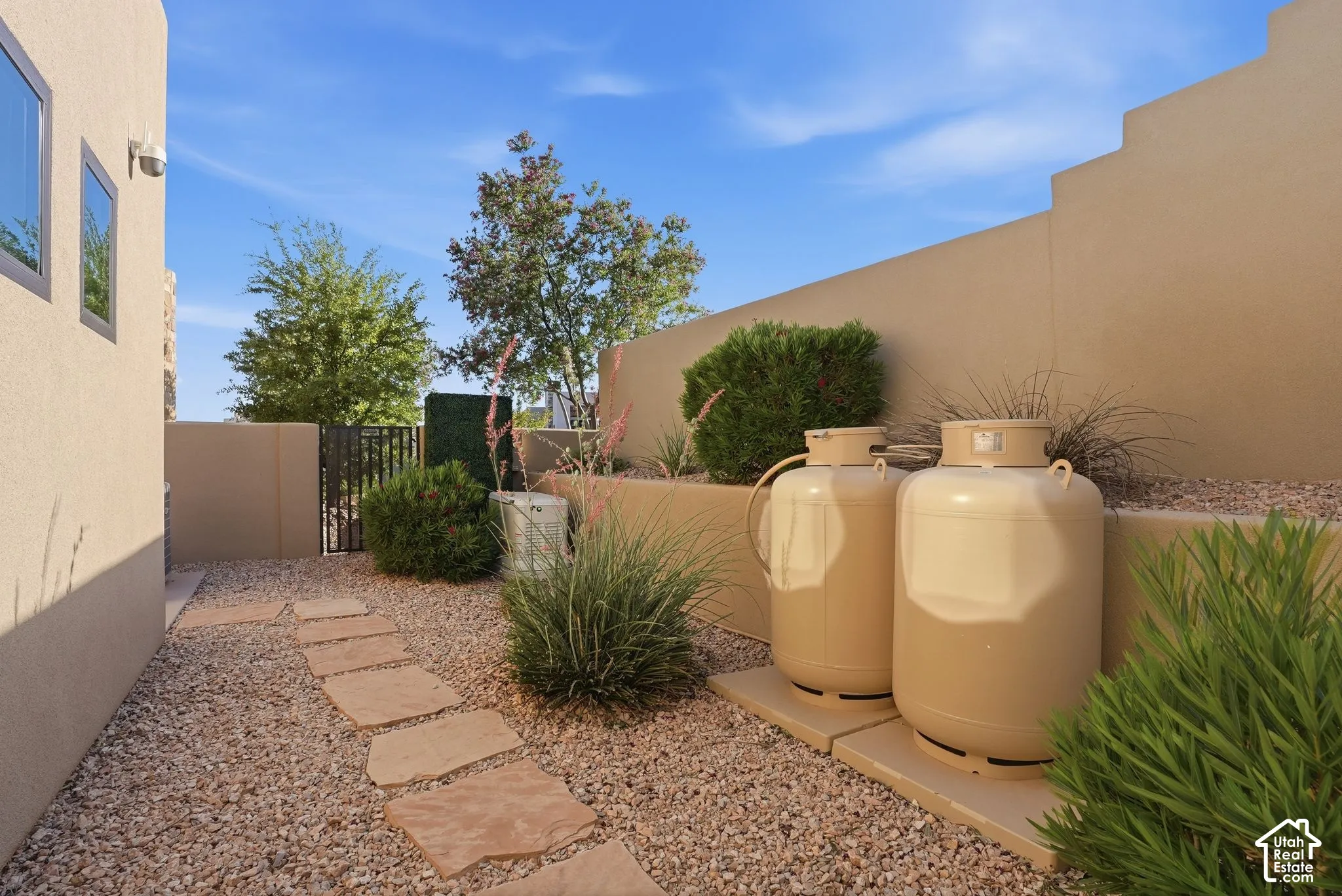 Xeriscape landscaping with a stone pathway, decorative gravel, and low-maintenance plantings