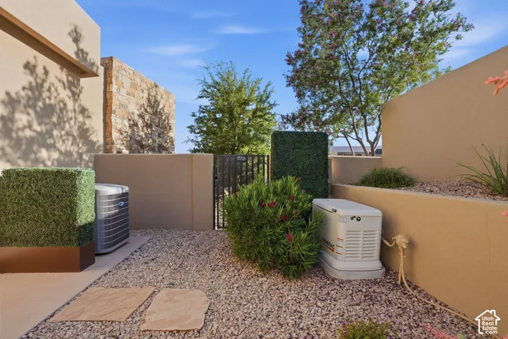 Xeriscape landscaping featuring gravel and mature plantings, complemented by a stone accent wall